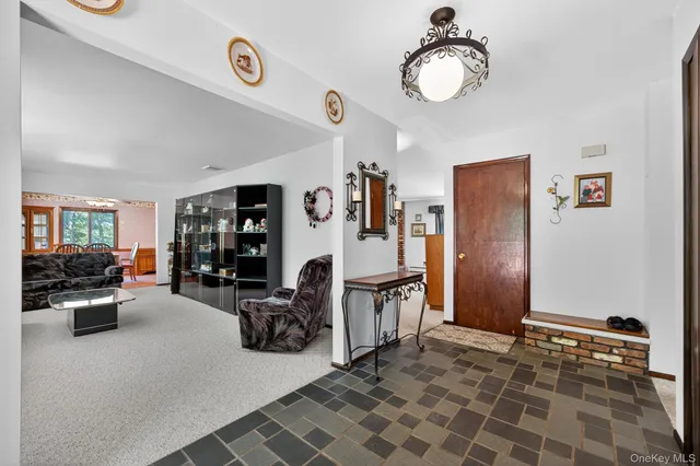 a view of a livingroom with furniture and a window