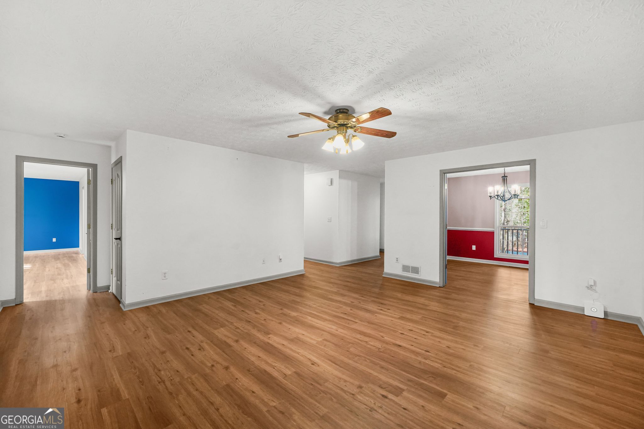 156 Pine Street Covington, GA 30014 - Photo 16 of 37 an empty room with wooden floor and chandelier fan