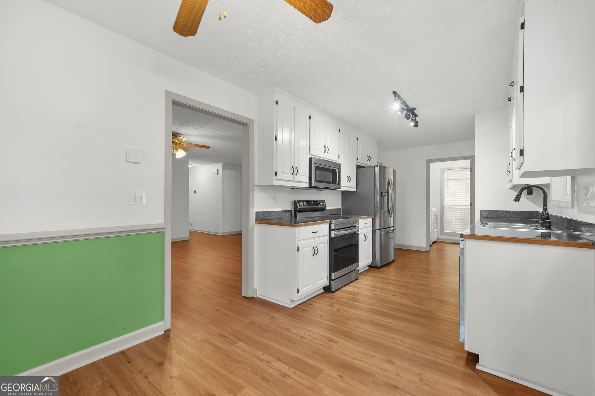 156 Pine Street Covington, GA 30014 - Photo 19 of 37 a kitchen with granite countertop a stove and a sink