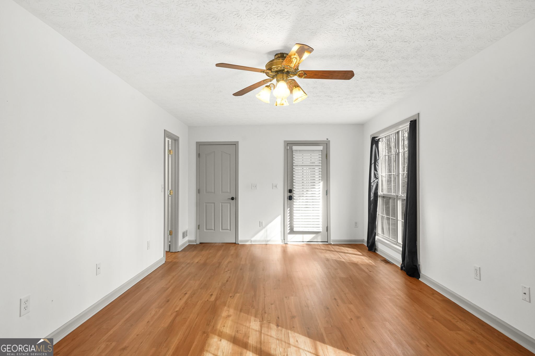 156 Pine Street Covington, GA 30014 - Photo 23 of 37 a view of empty room with wooden floor