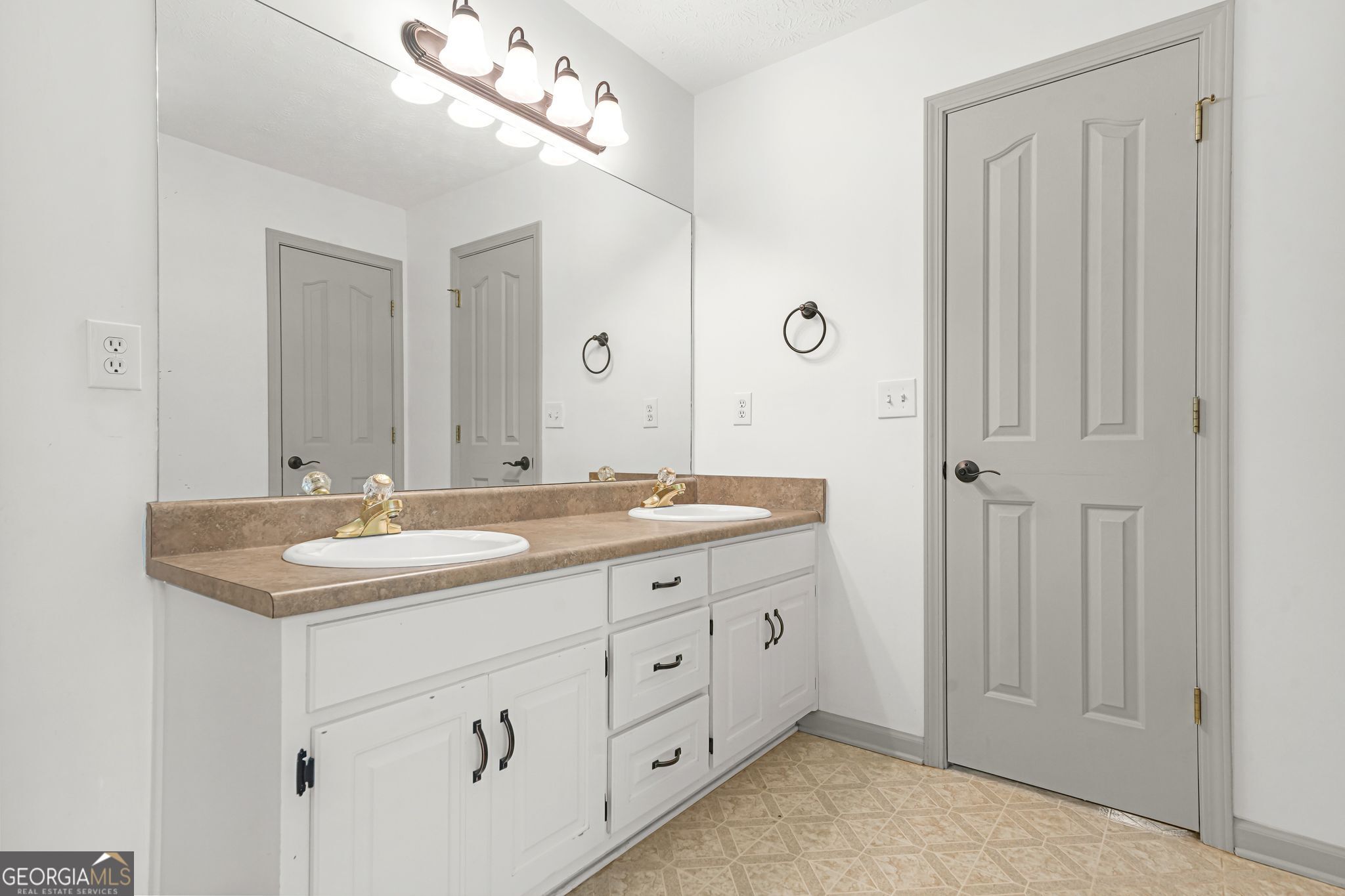 156 Pine Street Covington, GA 30014 - Photo 25 of 37 a bathroom with a double vanity sink and mirror