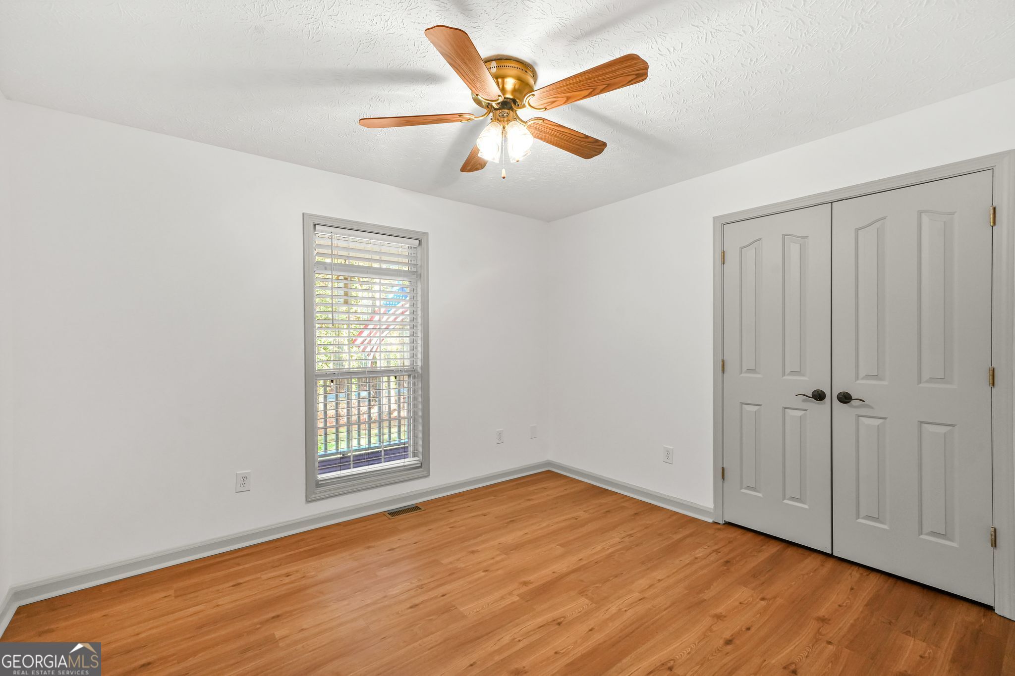 156 Pine Street Covington, GA 30014 - Photo 27 of 37 an empty room with wooden floor and windows