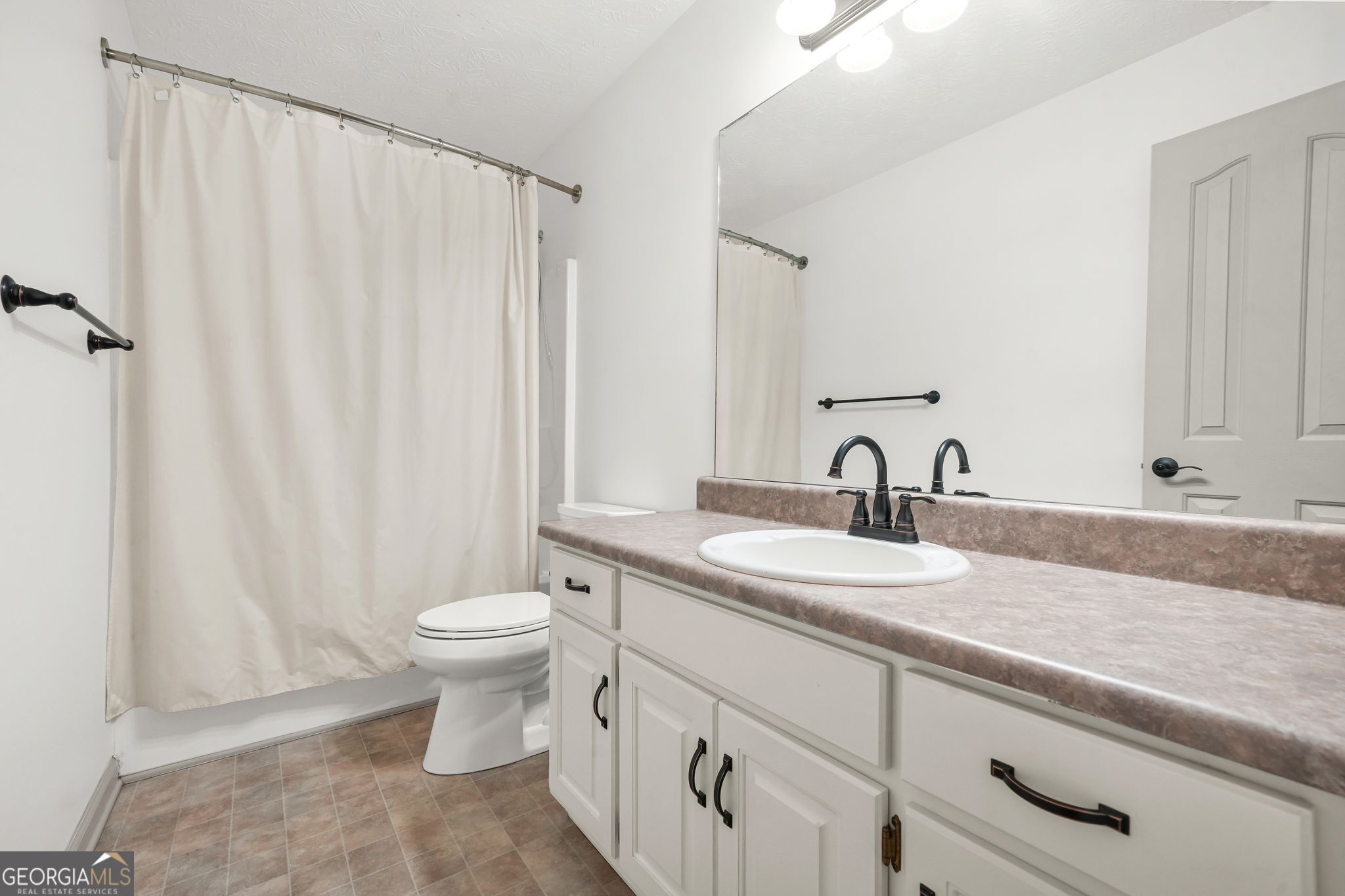 156 Pine Street Covington, GA 30014 - Photo 29 of 37 a bathroom with a sink a toilet and a mirror