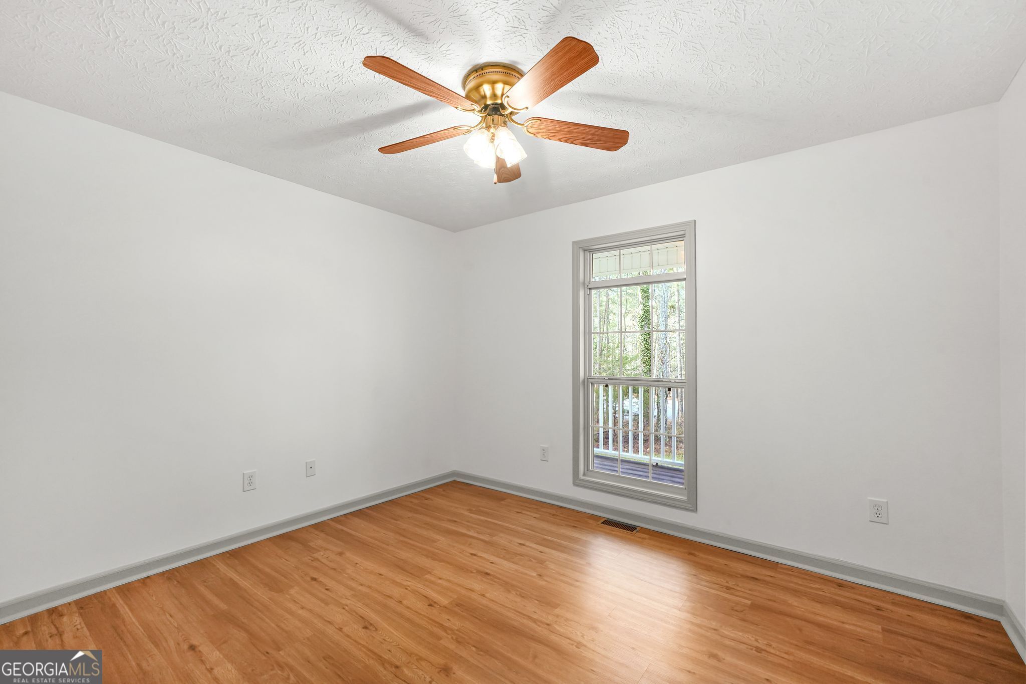 156 Pine Street Covington, GA 30014 - Photo 30 of 37 an empty room with wooden floor and ceiling fan