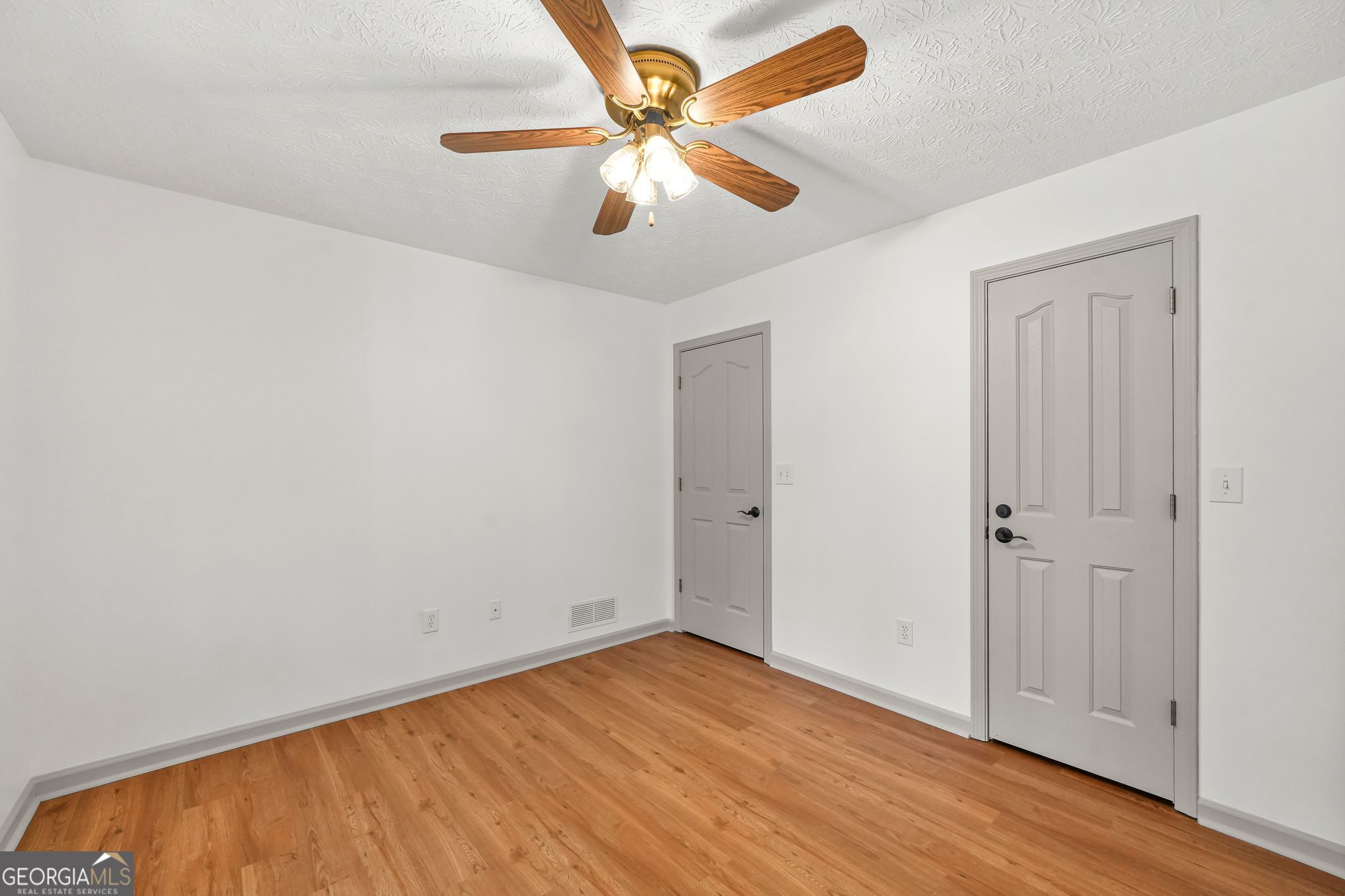 156 Pine Street Covington, GA 30014 - Photo 31 of 37 an empty room with wooden floor ceiling fan and window