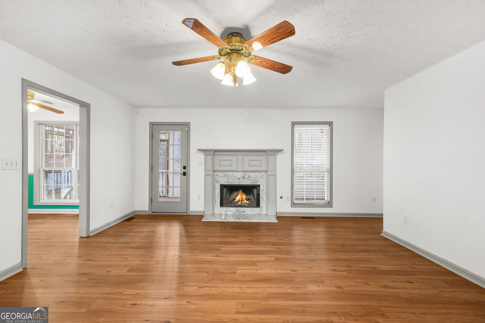 156 Pine Street Covington, GA 30014 - Photo 4 of 37 a view of an empty room with window and fireplace