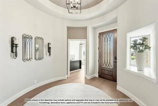 a dining room with furniture a rug and a chandelier