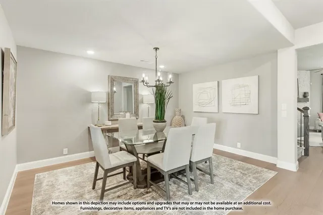 a view of a dining room with furniture and a chandelier