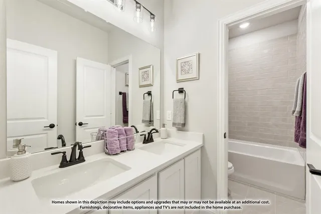 a living room with furniture a fireplace and a chandelier