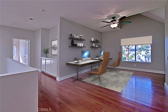 a view of a hallway with closet and wooden floor