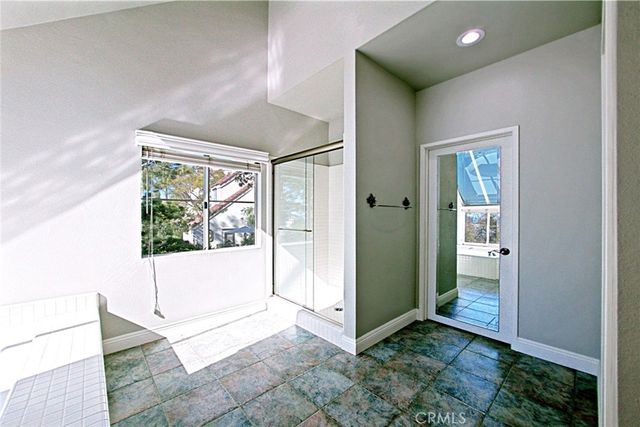 a spacious bathroom with a tub sink and a mirror