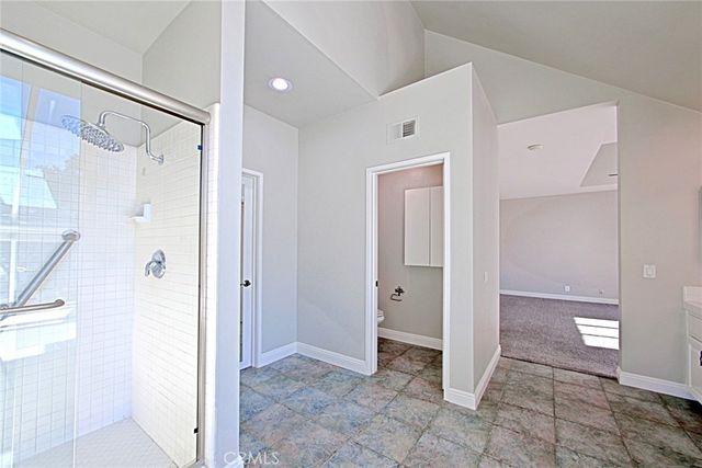 a spacious bathroom with a double vanity sink a mirror and a bathtub