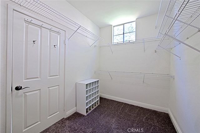 a view of a livingroom with an empty space and a window