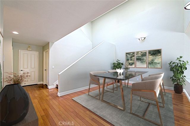 a view of a livingroom with furniture and hardwood floor