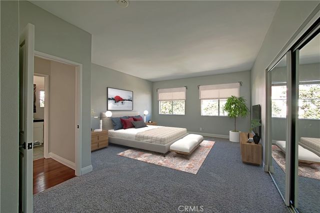 a bedroom with a bed and a couch