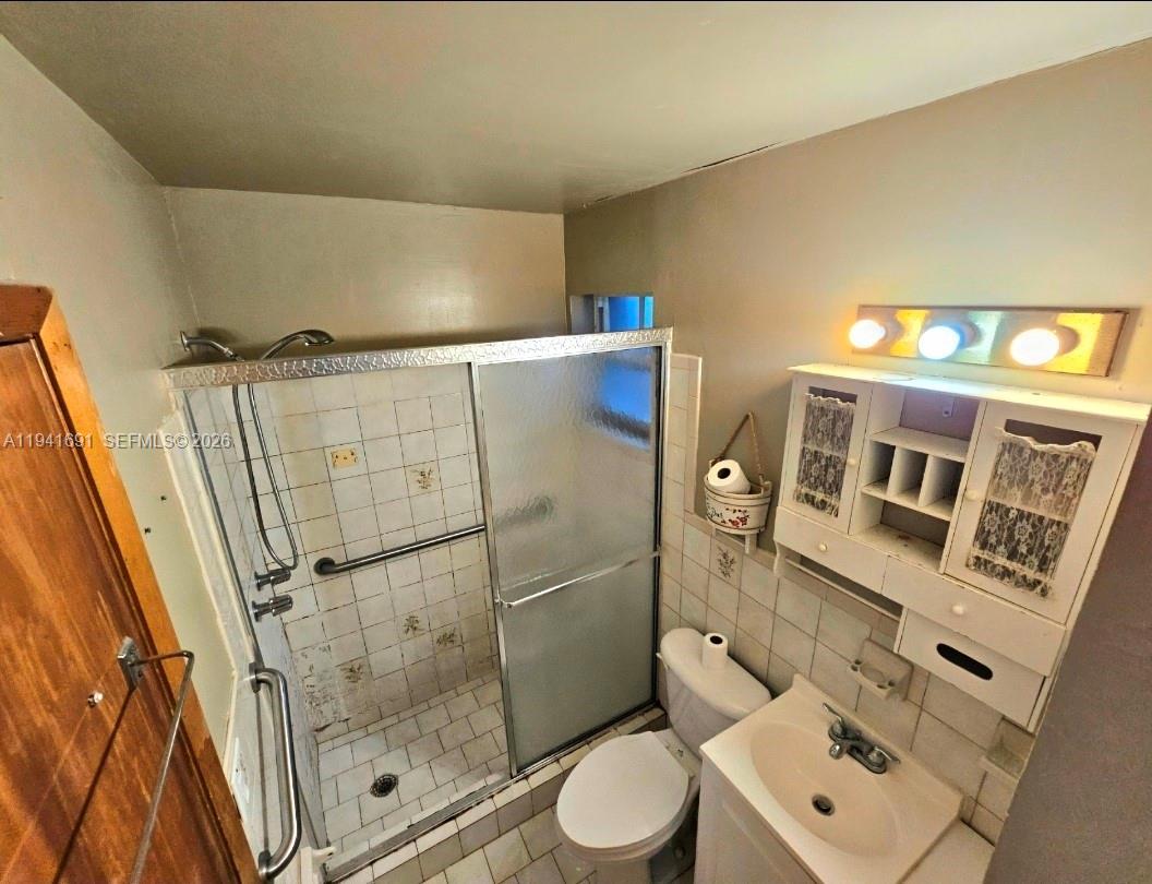3015 Southwest 24th Terrace Miami, FL 33145 - Photo 16 of 22 a bathroom with a shower toilet and sink