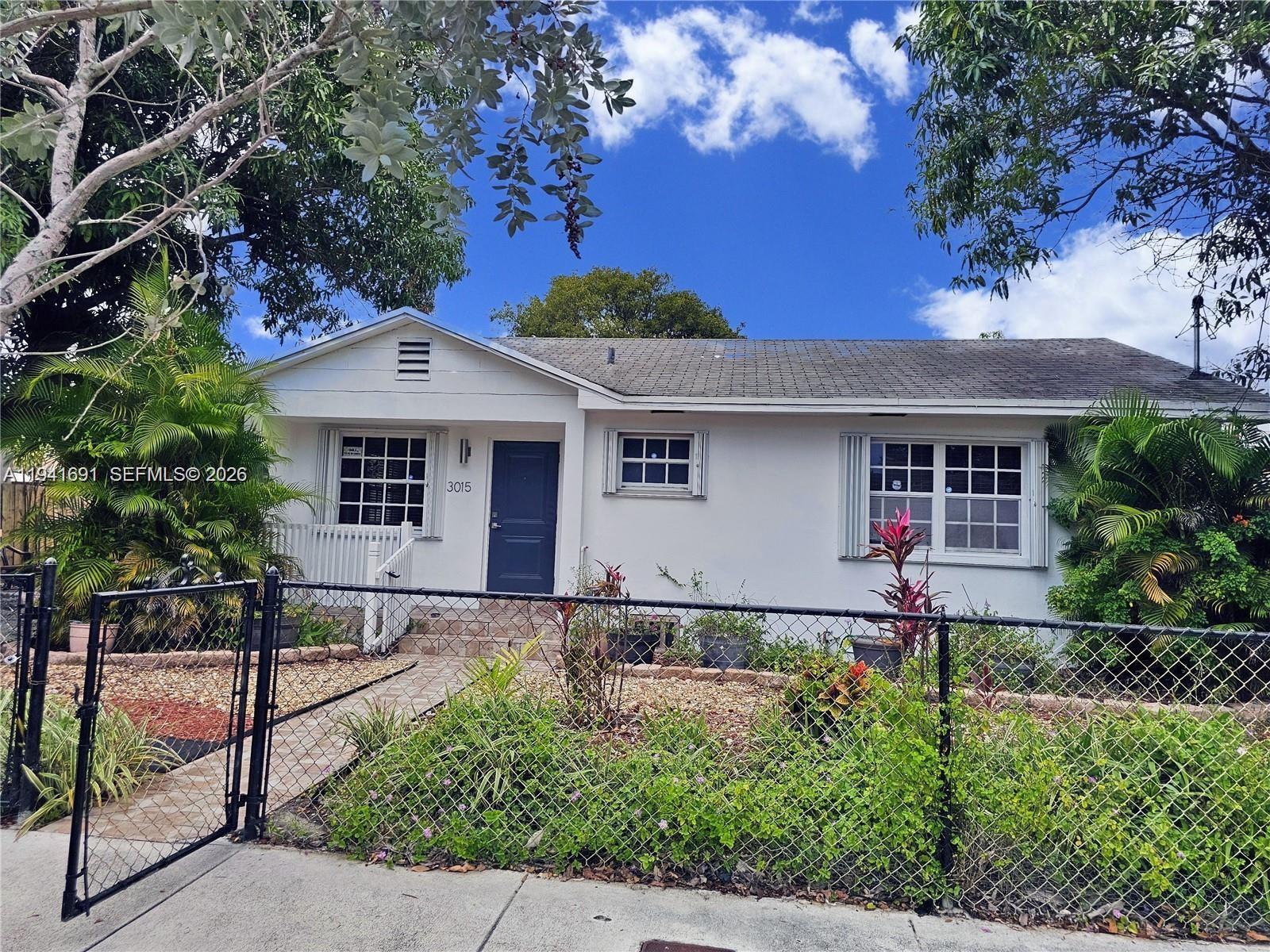 3015 Southwest 24th Terrace Miami, FL 33145 - Photo 2 of 22 front view of house with a yard and potted plants