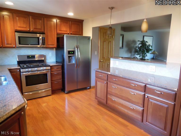 6470 State Road, Unit K6 Parma, OH 44134 - Photo 2 of 18 Beautiful new kitchen with a spacious open floor layout that has been been upgraded with cherry cabinets,lighting,flooring and granite counter tops! all new appliances stay!