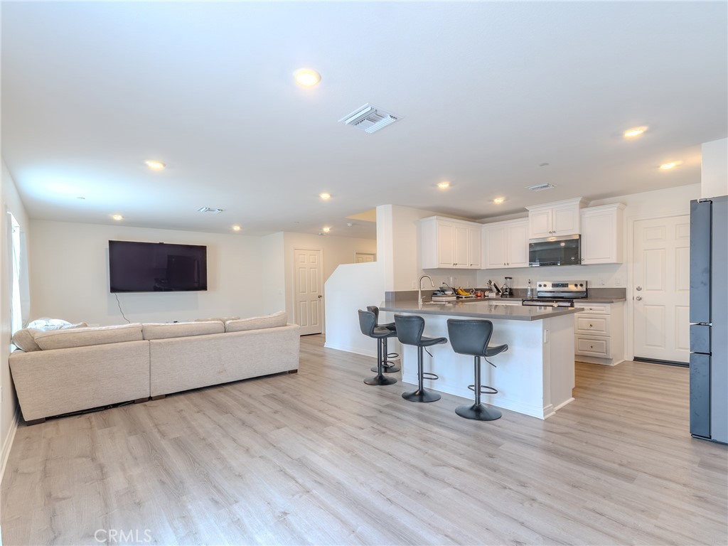 25602 Pne Rdg Road Homeland, CA 92548 - Photo 11 of 35 a living room with couches and kitchen view with wooden floor