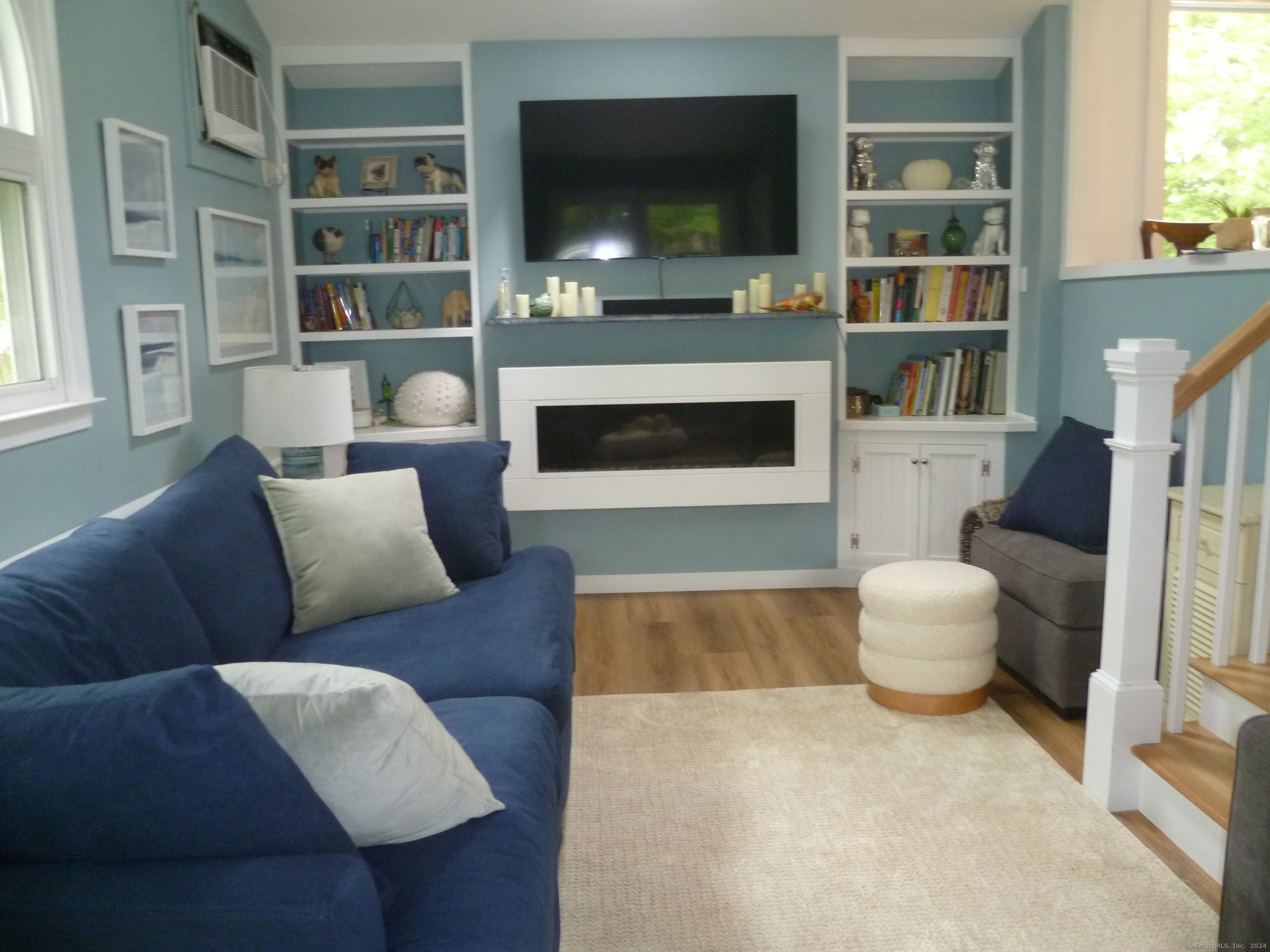 6 Sunset Lane Clinton, CT 06413 - Photo 10 of 27 The bonus/playroom off Kitchen has a TV, Propane Fireplace, bookshelves and games for children