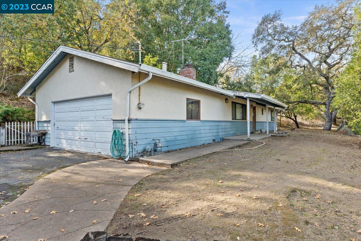a view of a house with a yard and garage