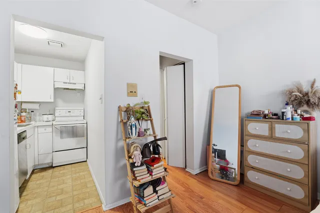 a storage room with cabinets and wooden floor