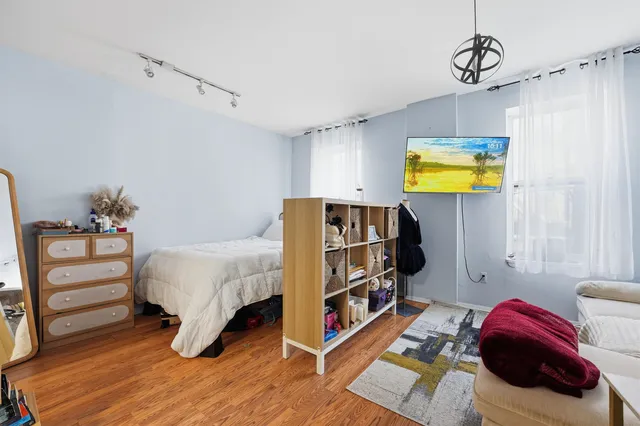 a bedroom with a bed and a chandelier