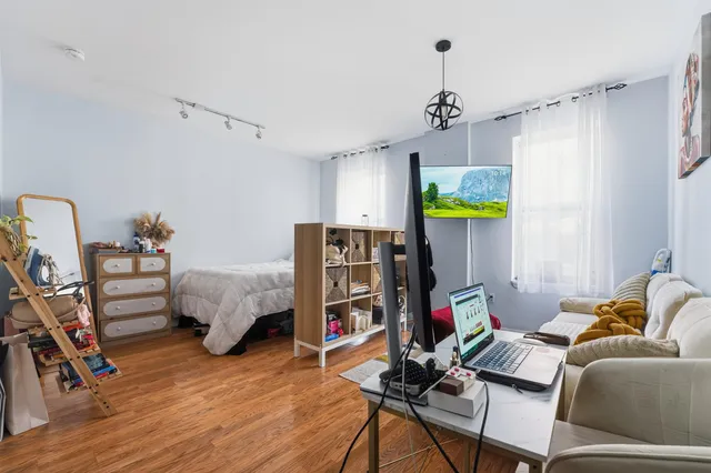 a bedroom with furniture and a wooden floor