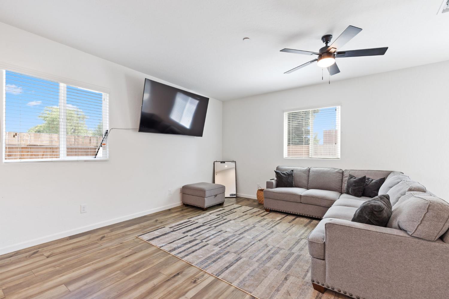 282 Rosebriar Street Madera, CA 93638 - Photo 11 of 28 a living room with furniture and a flat screen tv
