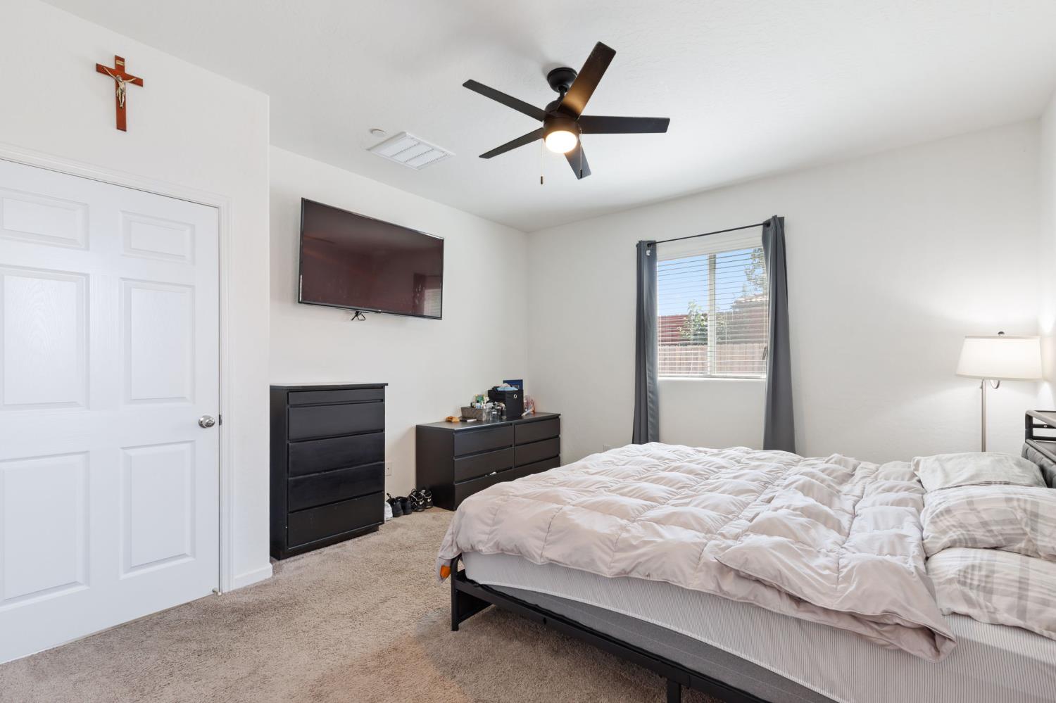 282 Rosebriar Street Madera, CA 93638 - Photo 12 of 28 a bedroom with a bed and a flat screen tv