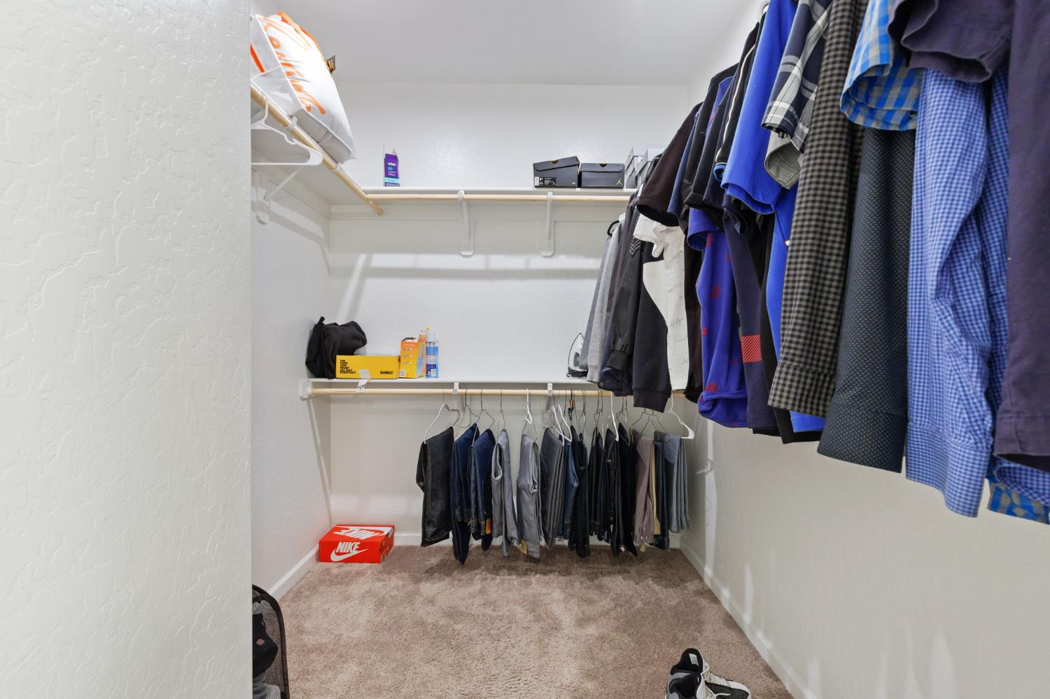 282 Rosebriar Street Madera, CA 93638 - Photo 14 of 28 a view of walk in closet with clothes and shoes