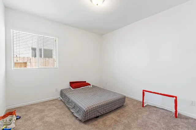 a living room with a bed and a table