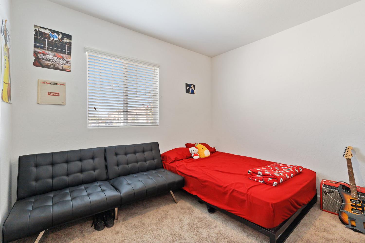 282 Rosebriar Street Madera, CA 93638 - Photo 20 of 28 a living room with a couch and a dresser next to a window