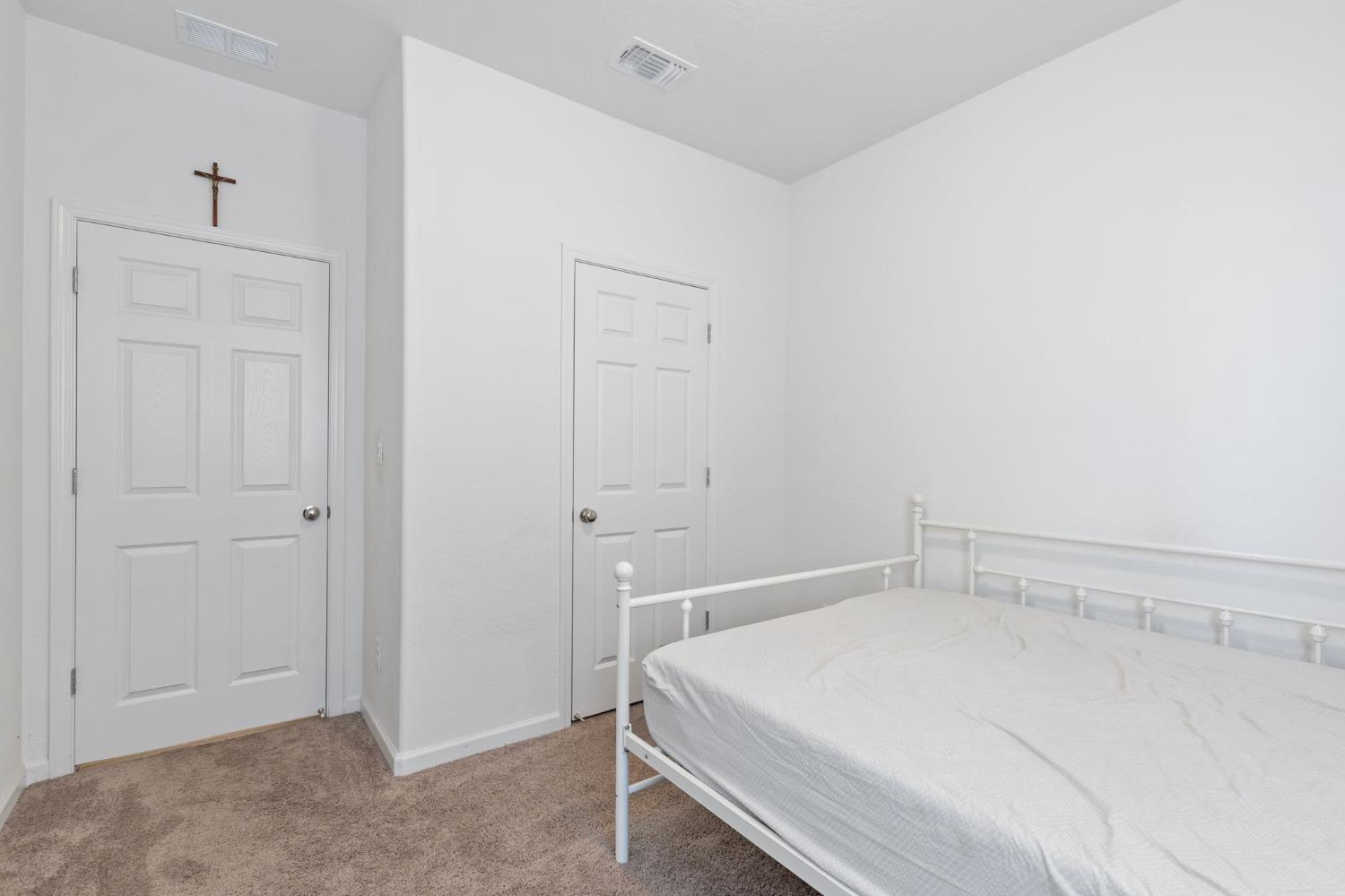 282 Rosebriar Street Madera, CA 93638 - Photo 21 of 28 a bedroom with a bed and closet