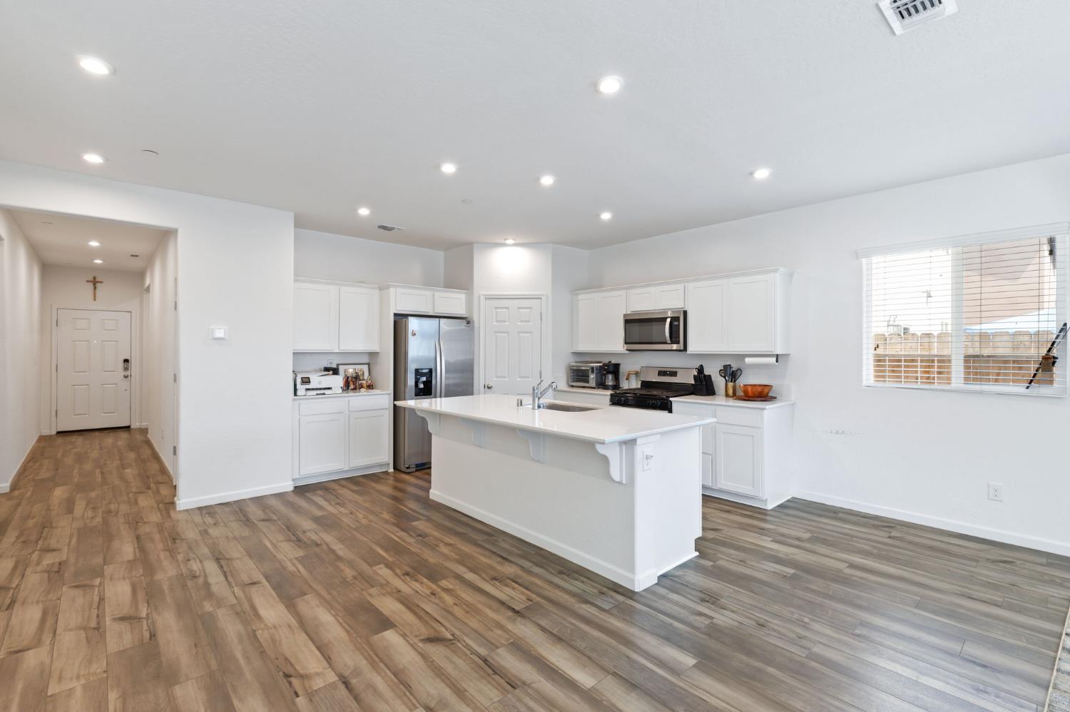 282 Rosebriar Street Madera, CA 93638 - Photo 4 of 28 a kitchen with a refrigerator and a stove top oven