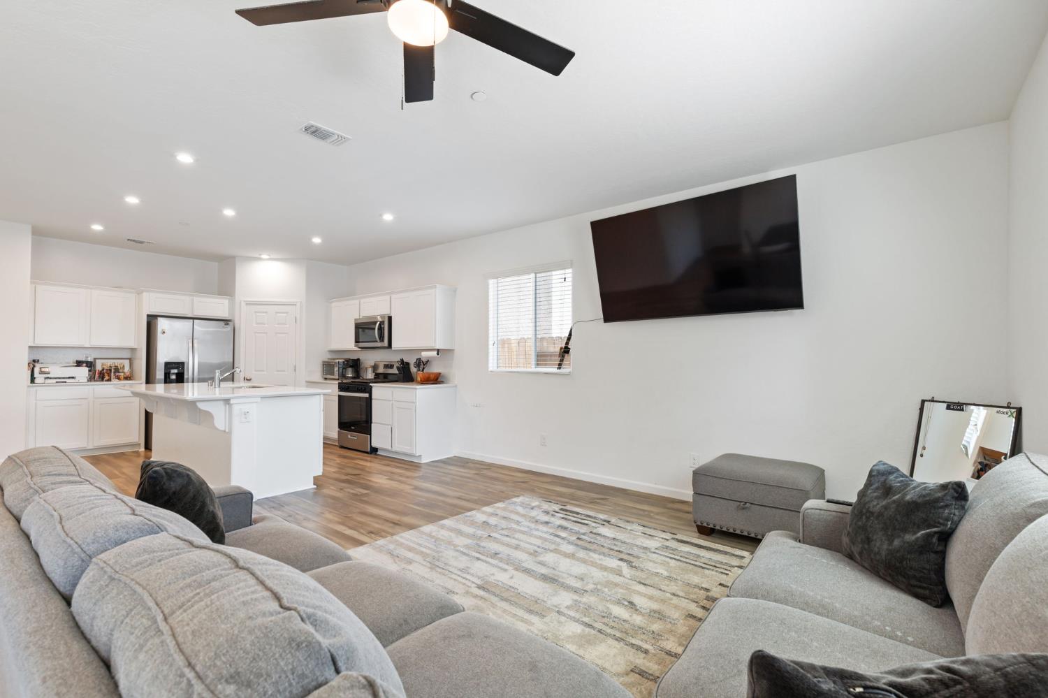282 Rosebriar Street Madera, CA 93638 - Photo 6 of 28 a living room with furniture and a flat screen tv