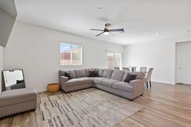 a living room with furniture and a wooden floor