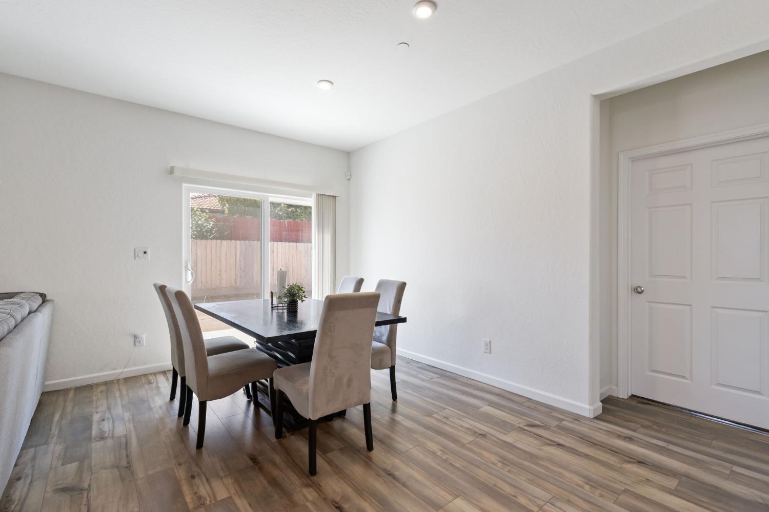 282 Rosebriar Street Madera, CA 93638 - Photo 10 of 28 a view of a dining room with furniture and wooden floor