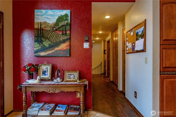 a view of a hallway with furniture and wooden floor