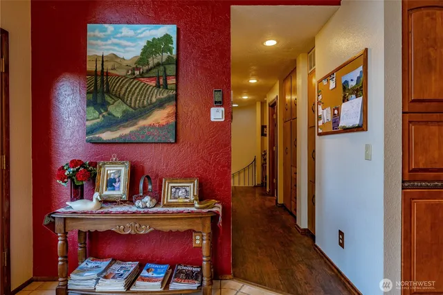 a view of a hallway with furniture and wooden floor