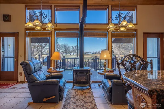 a living room with furniture a chandelier and a fireplace
