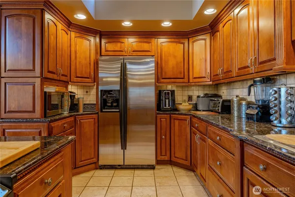 a kitchen with stainless steel appliances a refrigerator and cabinets