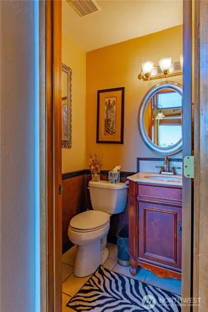 a bathroom with a toilet a sink and mirror