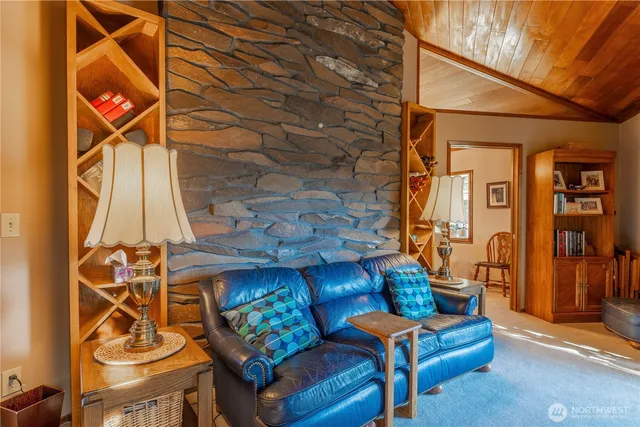 a living room with furniture a flat screen tv and a window