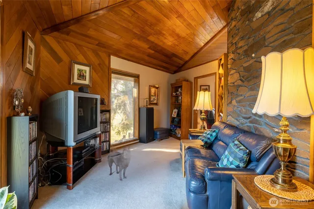 a living room with furniture a chandelier and a large window