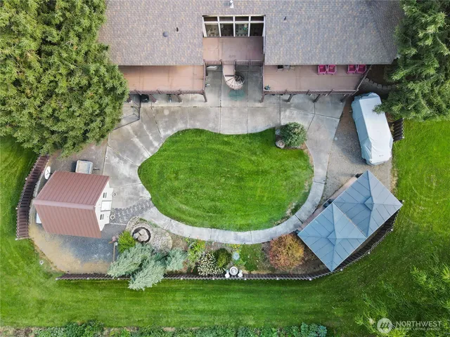 an aerial view of a house with a garden and trees