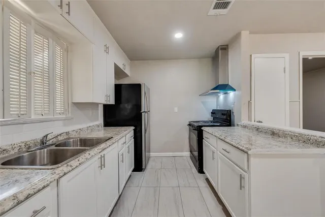 a kitchen that has a sink and a stove in it