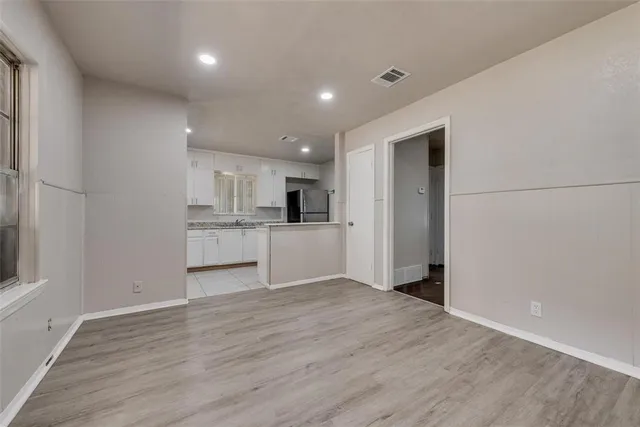 a view of a kitchen with wooden floor and windows