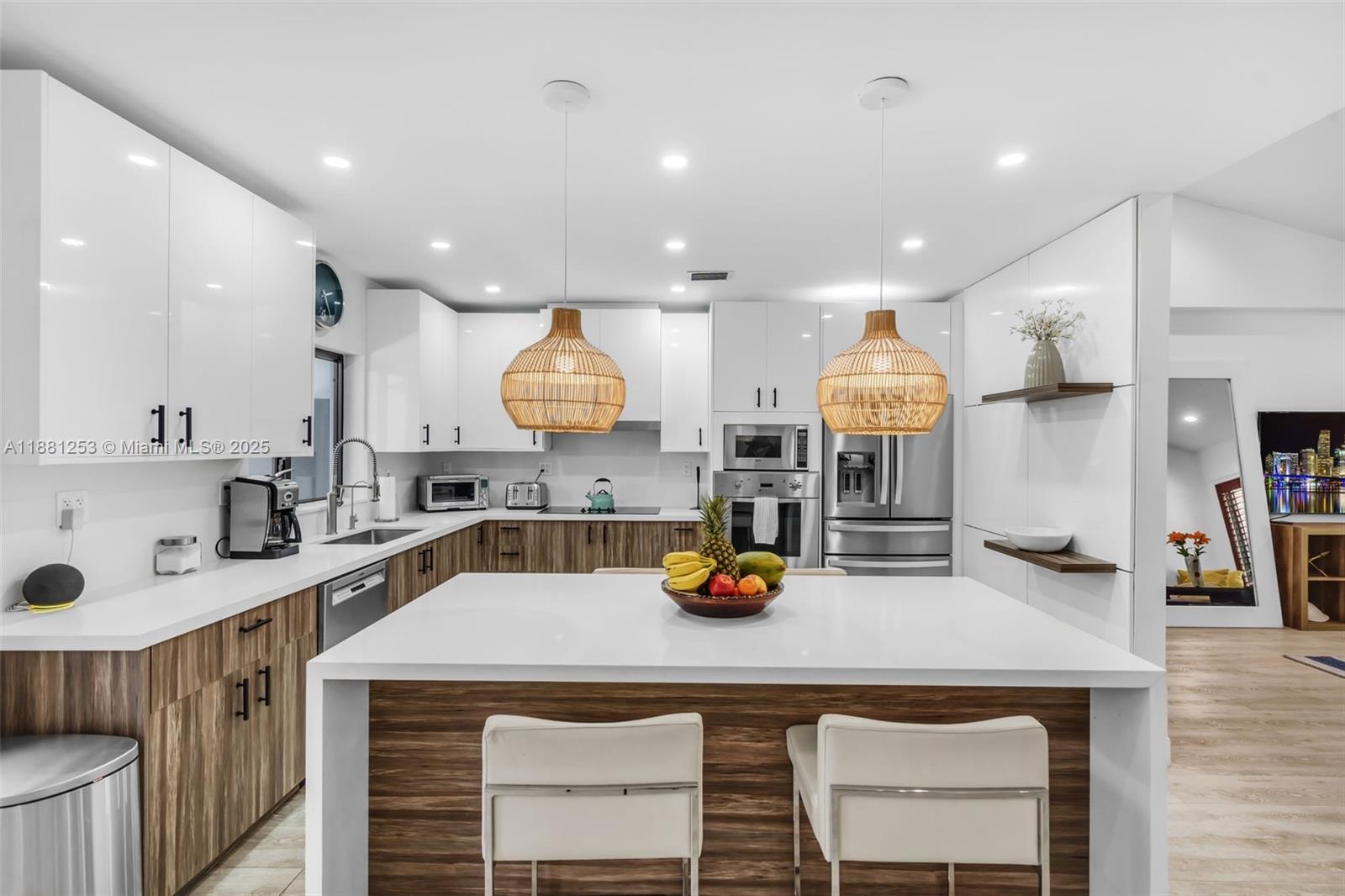 340 Woodcrest Road Key Biscayne, FL 33149 - Photo 11 of 51 a kitchen with a sink a stove and cabinets