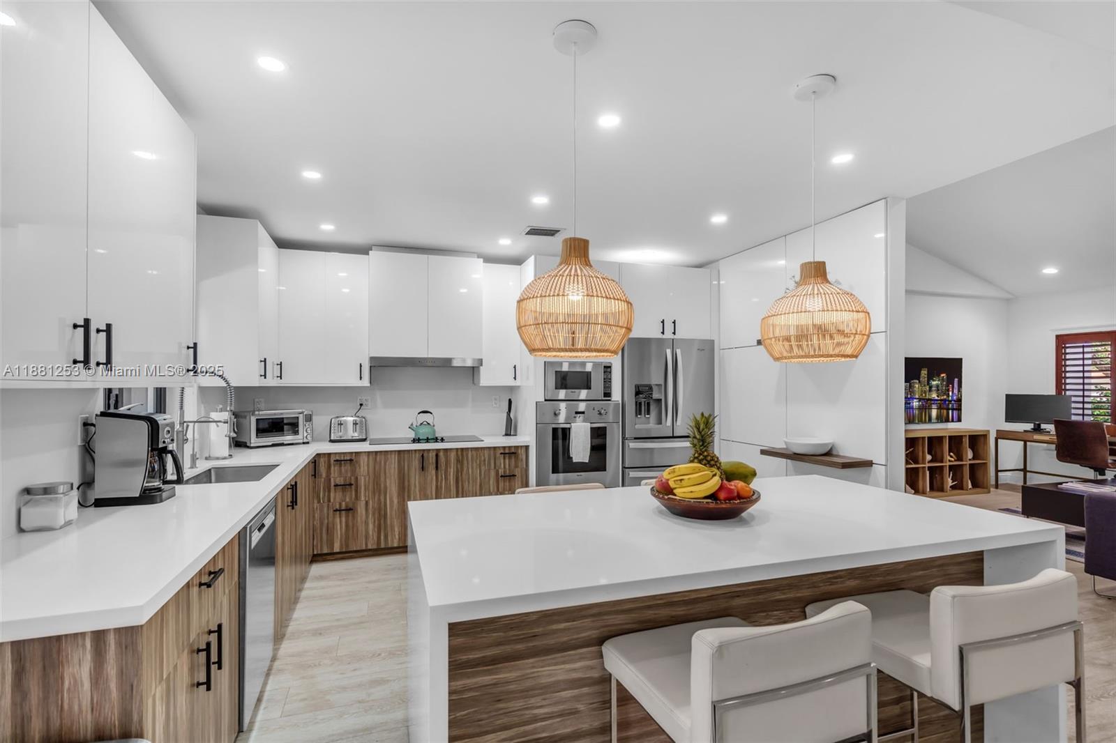 340 Woodcrest Road Key Biscayne, FL 33149 - Photo 12 of 51 a kitchen with a sink appliances and cabinets
